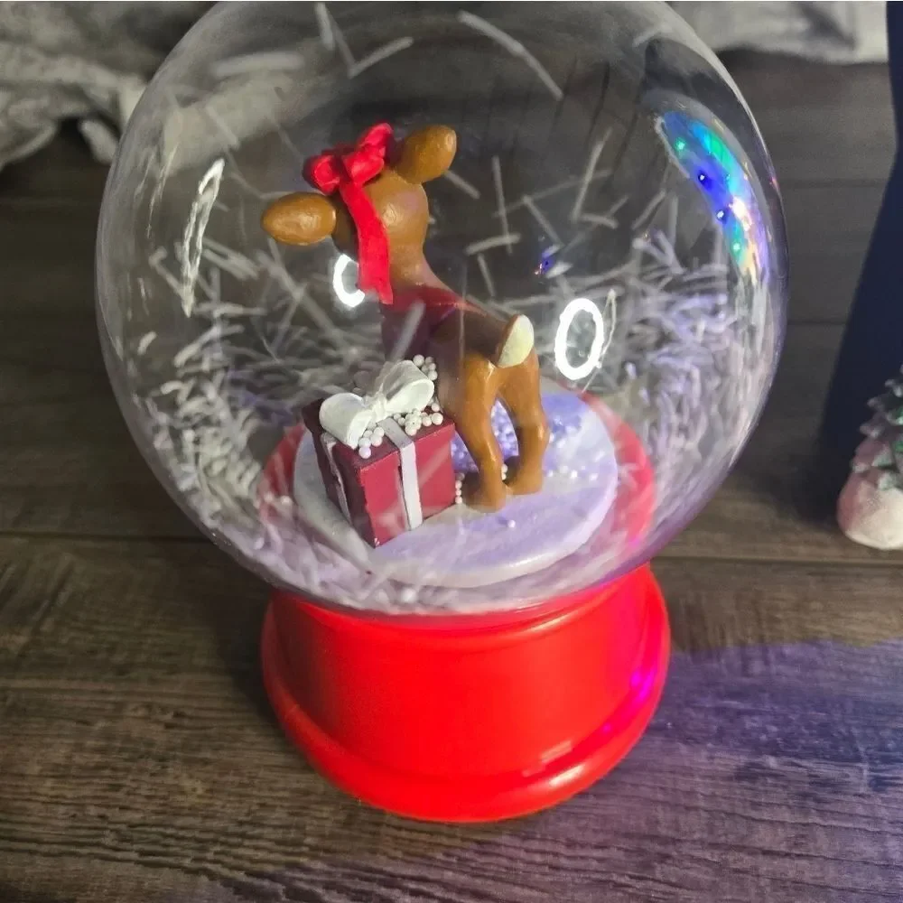 Two snow globes, animated snow, one is musical  and lights up htf